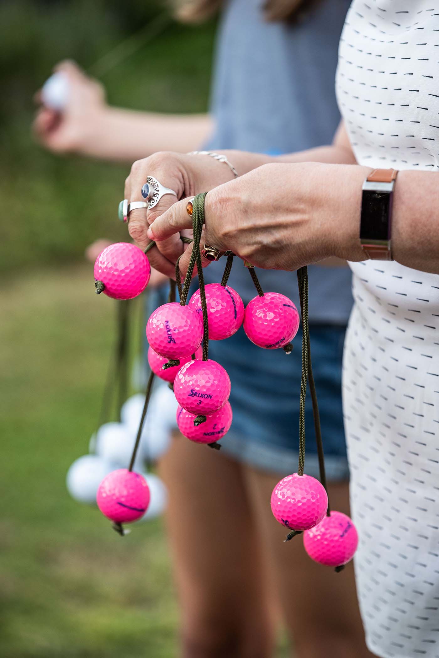 Hands holding ladder golf balls