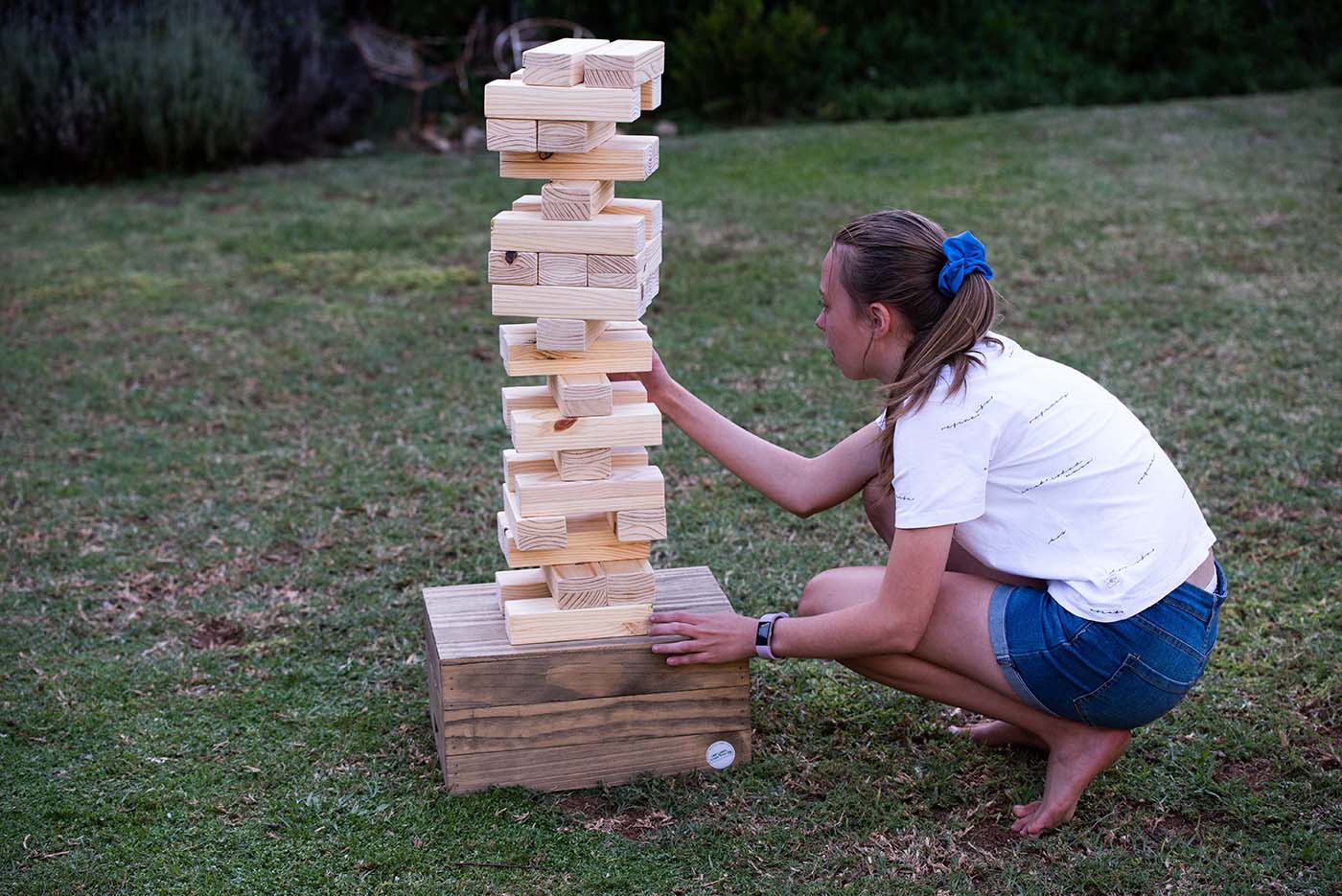 Giant Jenga being played by teenager